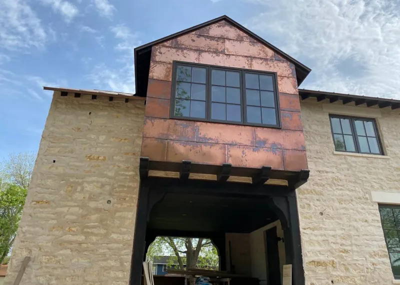 Copper metal panel facade on a stone building for Skylight Installation in Cortez