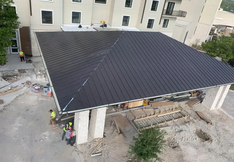 Metal roofing installation team working on a commercial building in Cortez